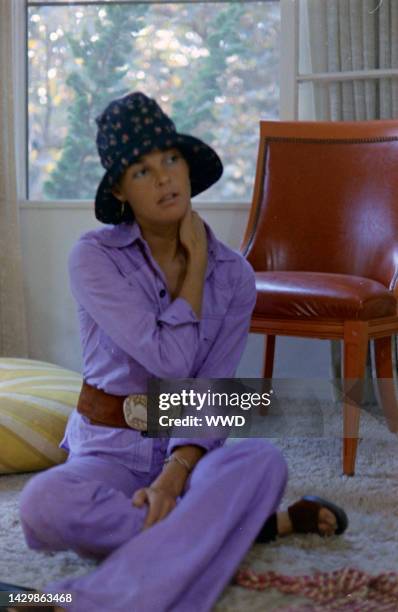 Actress Ali MacGraw sits on rug and answers questions during an interview in her friend's apartment.