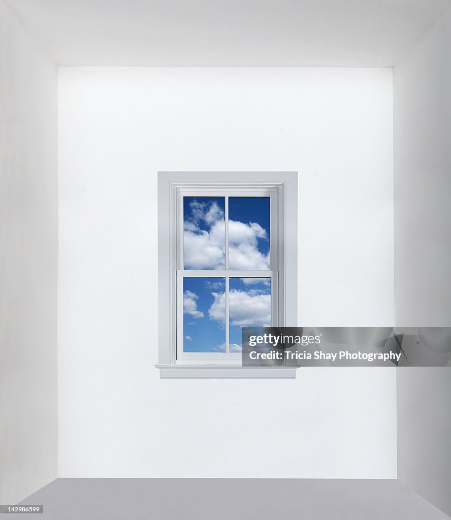 Window with blue sky in white room