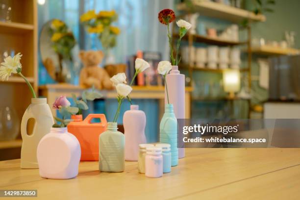 flower vase with recycle plastic bottles. - recycled-art stock pictures, royalty-free photos & images