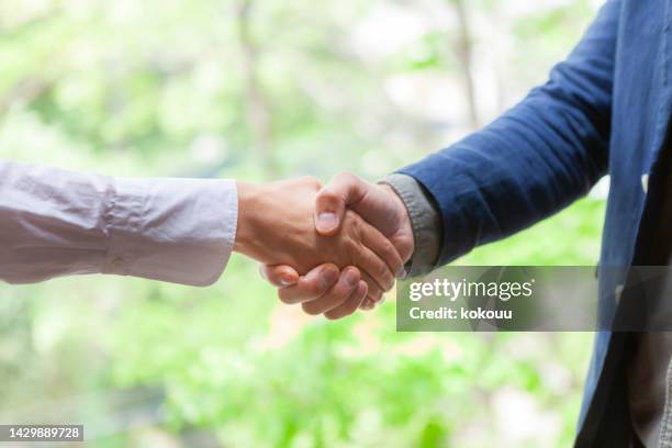 close-up of shaking hands - social contract stock pictures, royalty-free photos & images