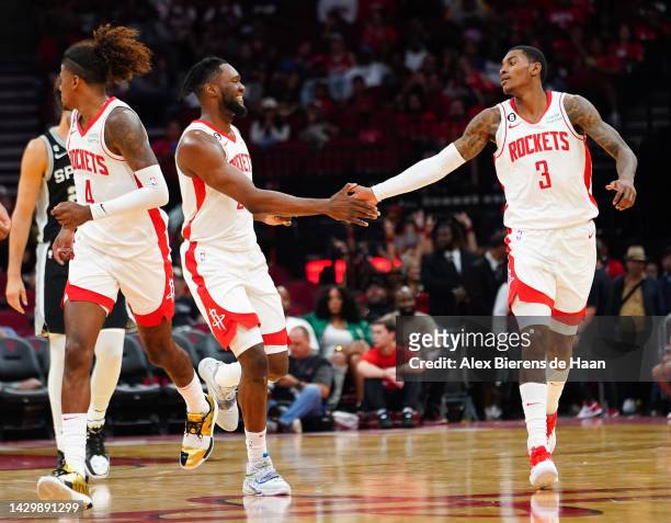 Bruno Fernando of the Houston Rockets hi fives Kevin Porter Jr. #3 after a play during the game against the San Antonio Spurs at Toyota Center on...