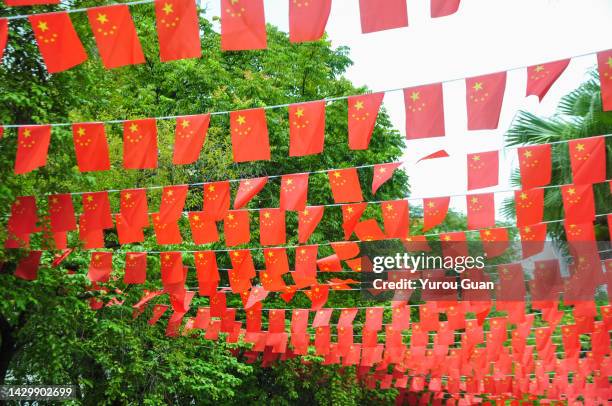 the flags hung in jiangmen donghu park in guangdong, for national day of the people's republic of china. - guangdong communist party stock pictures, royalty-free photos & images