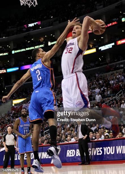 Blake Griffin of the Los Angeles Clippers dunks over Thabo Sefolosha of the Oklahoma City Thunder at Staples Center on April 16, 2012 in Los Angeles,...