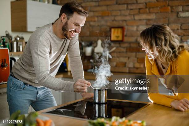 happy couple enjoying while boiling water at the kitchen. - cezve stockfoto's en -beelden