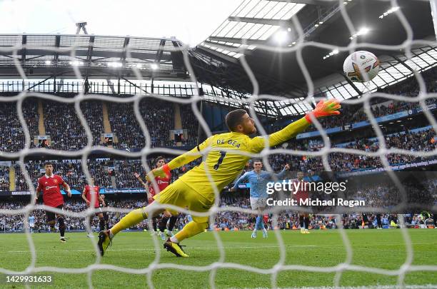 Phil Foden of Manchester City scores his third goal for his hat-trick past David De Gea of Manchester United during the Premier League match between...