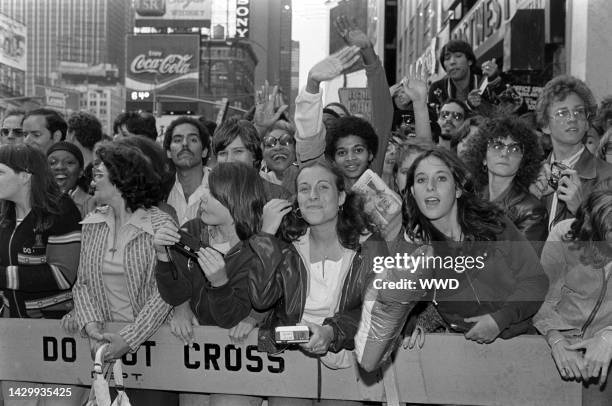 Fans watch celebrity arrivals during the local premiere of "Grease" in New York City on June 13, 1978.