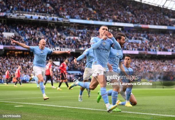 Phil Foden of Manchester City celebrates their sides first goal during the Premier League match between Manchester City and Manchester United at...