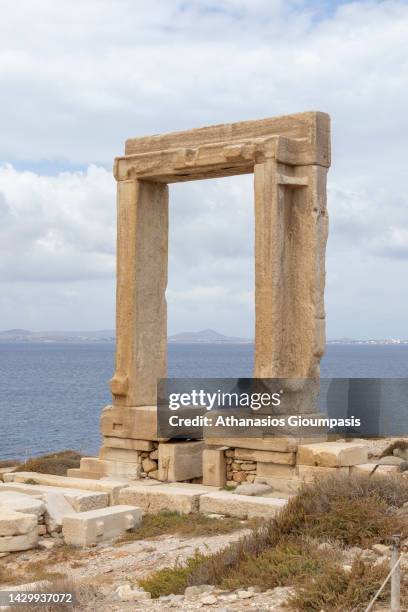 The ruins of Apollo Temple or Portara on September 27, 2022 in Santorini, Greece. Naxos Temple of Apollo is a huge marble gate and the single...