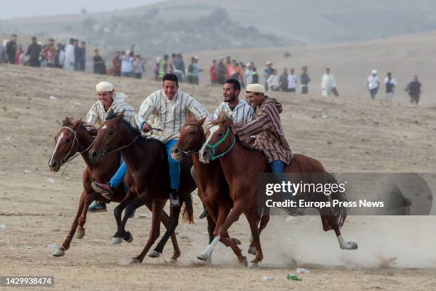 Several riders arrive at the finish line of the Mata International Equestrian Festival, in the desert, on October 2 in the region of...