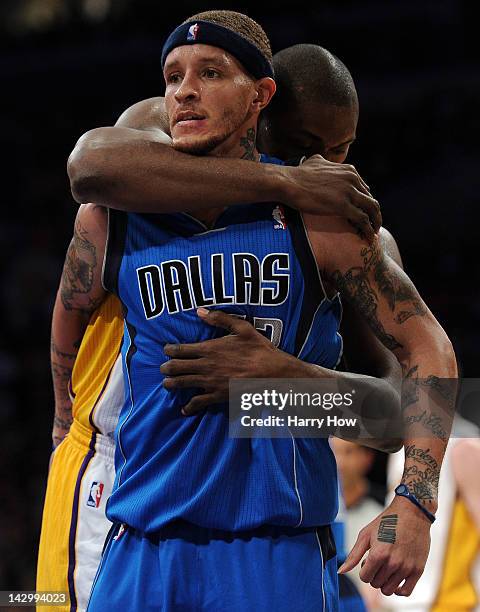 Metta World Peace of the Los Angeles Lakers and Delonte West of the Dallas Mavericks get tangles under the basket during the first half at Staples...