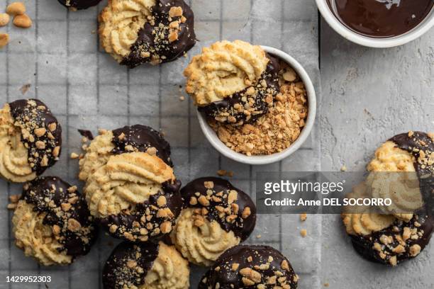 homemade christmas butter cookies with chocolate and nuts sprits - almond cookies stock pictures, royalty-free photos & images