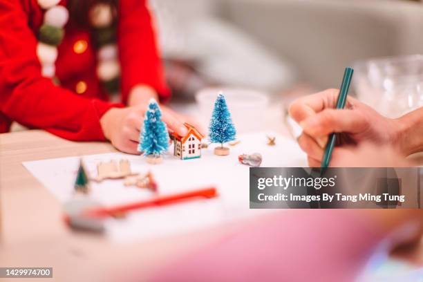 close-up of mom & daughter’s hands arranging & decorating some models which used for making christmas bauble during the festive period - s christmas festival stock-fotos und bilder