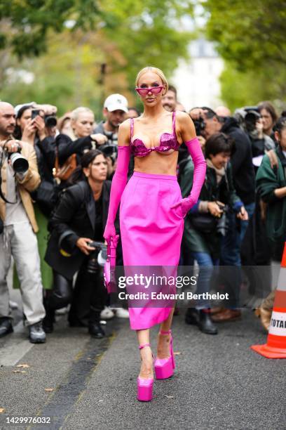 Christine Bently aka Christine Quinn wears neon pink cat eyes sunglasses, a neon pink sequined bra underwear, neon pink high gloves, a neon pink...