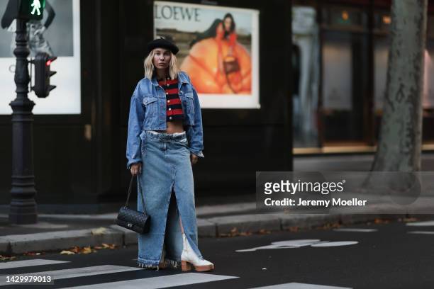 Karin Teigl wearing Zara long denim skirt, Zara jeans jacket, white H&M Studio shoes, Chanel 2.55 black leather bag, striped Zara cardigan during...