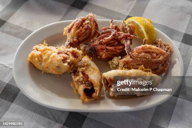 fried squid, calamari at a taverna in tavari, lesvos, greece - mytilene fotografías e imágenes de stock