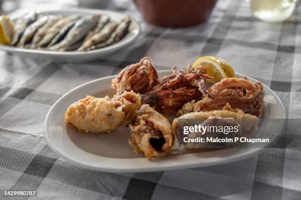 fried squid, calamari at a taverna in tavari, lesvos, greece - lesvos stock pictures, royalty-free photos & images