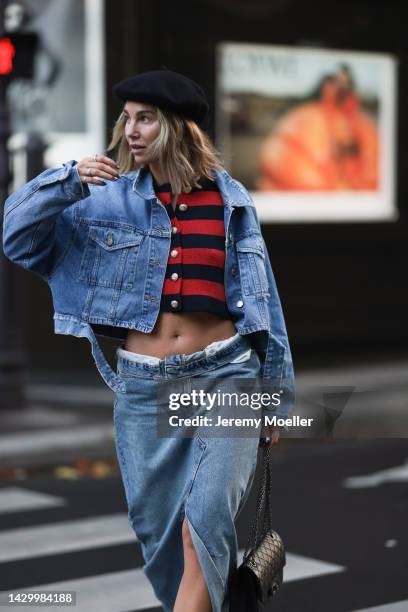 Karin Teigl wearing Zara long denim skirt, Zara jeans jacket, Chanel 2.55 black leather bag, striped Zara cardigan during Paris Fashion Week on...