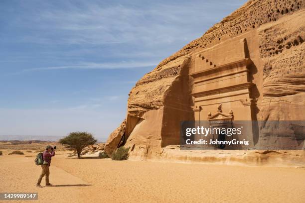 photographer visiting famous tombs in saudi arabia - mada'in saleh stock pictures, royalty-free photos & images