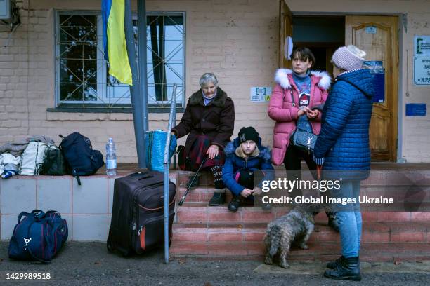 Refugees from Kupiansk are waiting for an evacuation bus to Kharkiv in the central square of the village on September 28, 2022 in Shevchenkove,...