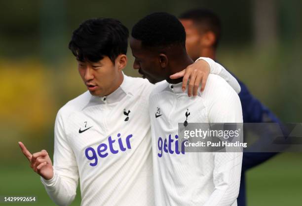 Heung-Min Son and Pape Matar Sarr of Tottenham Hotspur interact during a training session at Tottenham Hotspur Training Centre ahead of their UEFA...