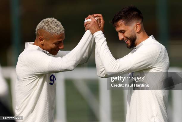 Richarlison and Rodrigo Bentancur of Tottenham Hotspur react during a training session at Tottenham Hotspur Training Centre ahead of their UEFA...