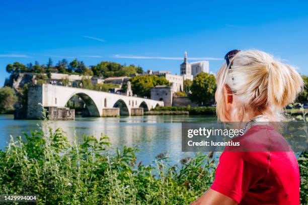 summer cycling beside pont saint benezet, avignon, france - rhone stock pictures, royalty-free photos & images