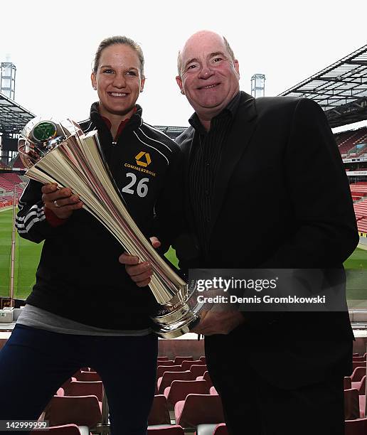Manager Siegfried Dietrich of Frankfurt and goalkeeper Desiree Schumann pose with the DFB Cup trophy during the Women's DFB Cup Final press...