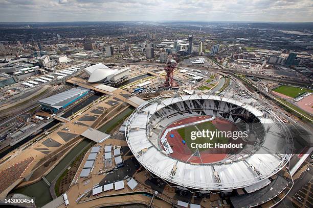 In this handout image provided by the The London Organising Committee of the Olympic Games an aerial view of the Olympic Stadium, Aquatics Centre and...