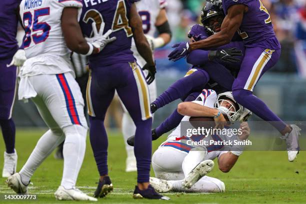 Quarterback Josh Allen of the Buffalo Bills is tackled as he rushes with the ball against the Baltimore Ravens at M&T Bank Stadium on October 02,...