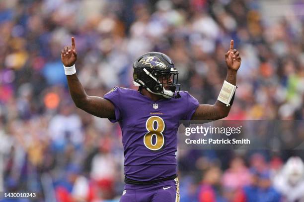 Quarterback Lamar Jackson of the Baltimore Ravens celebrates after teammate J.K. Dobbins scored a touchdown in the first quarter against the Buffalo...