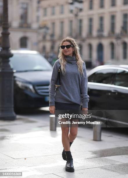 Sue Giers wearing The Frankie Shop checked mini skirt, SoSue grey knit sweater, black Celine shades, black Celine boots and Louis Vuitton clutch...