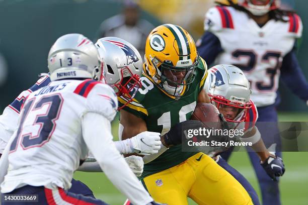 Randall Cobb of the Green Bay Packers is brought down by Devin McCourty of the New England Patriots during a game at Lambeau Field on October 02,...