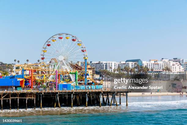 los angeles skyline with santa monica pier on a sunny day, california, usa - santa monica skyline stock pictures, royalty-free photos & images