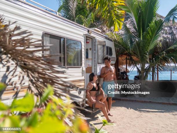 multiracial couple camping by the beach in mexico - hot filipina women stockfoto's en -beelden