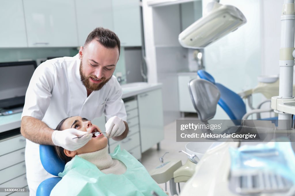 Female Feeling Pain And Discomfort While Getting Teeth Fixed By Male Dentist