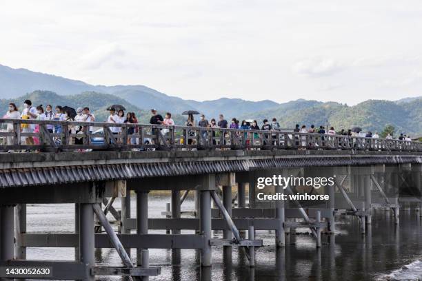 togetsu-kyo bridge in kyoto, japan - arashiyama stock pictures, royalty-free photos & images
