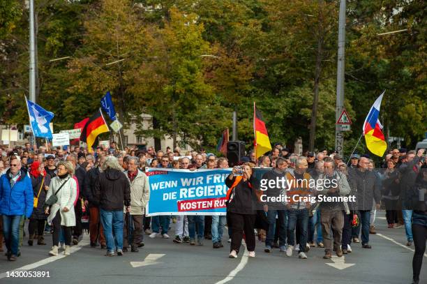 Protester's at a demonstration against high energy prices and German foreign policy over the conflict in Ukraine carrying a banner stating 'When we...
