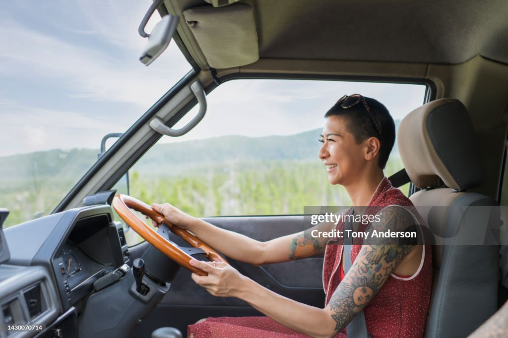 Young woman driving camper van