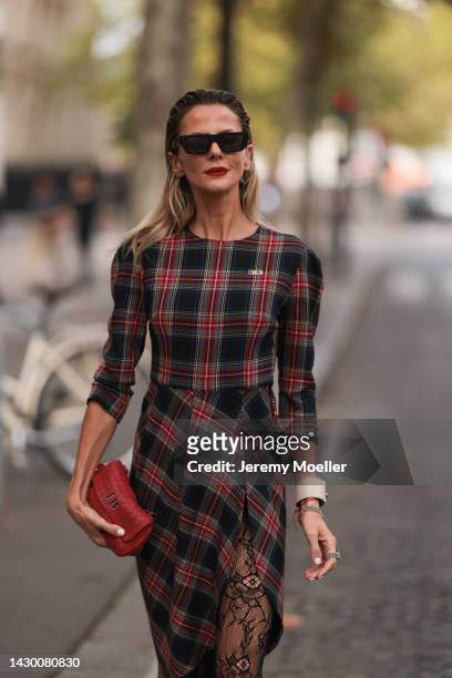 Jimena Buttigliengo seen wearing a come on look with off-white shades and Christian Dior black boots on October 02, 2022 in Paris, France.