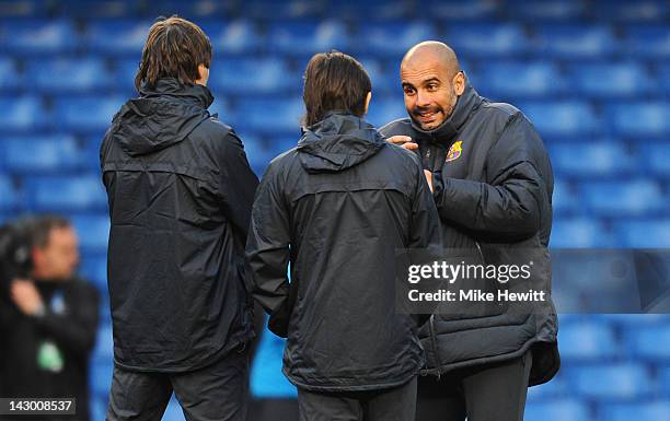 Coach Pep Guardiola of Barcelona chats with his backroom staff during a training session ahead of their UEFA Champions League semi-final first leg...