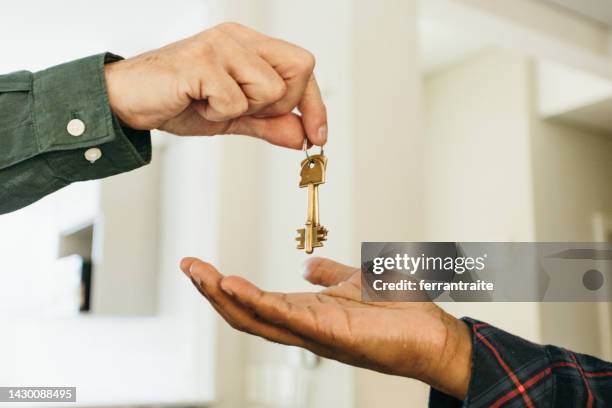 handing house keys - landlord stock pictures, royalty-free photos & images
