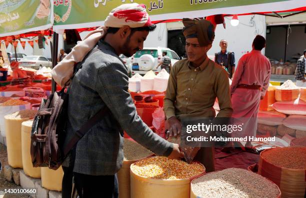 Yemeni shoppers visit an open grain market to buy grains during a fair on October 03, 2022 in Sana'a, Yemen.