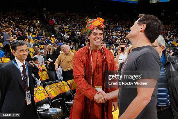 Tim Draper shakes the hand of Mark Cuban, owner of the Dallas Mavericks during the game between the Dallas Mavericks and the Golden State Warriors on...