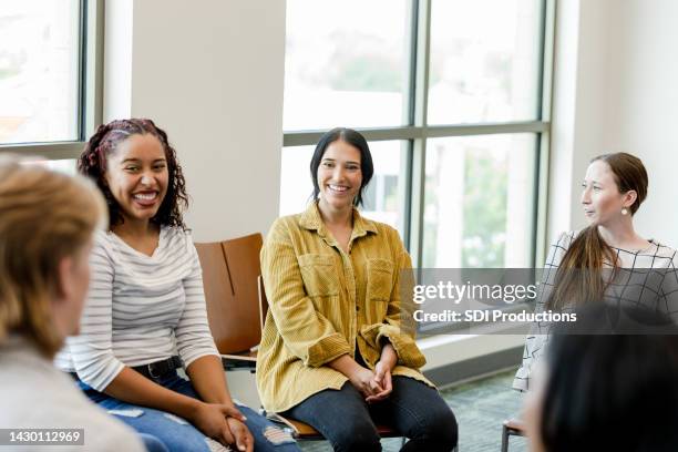 young adults gather for group therapy - terapia-de-grupo imagens e fotografias de stock