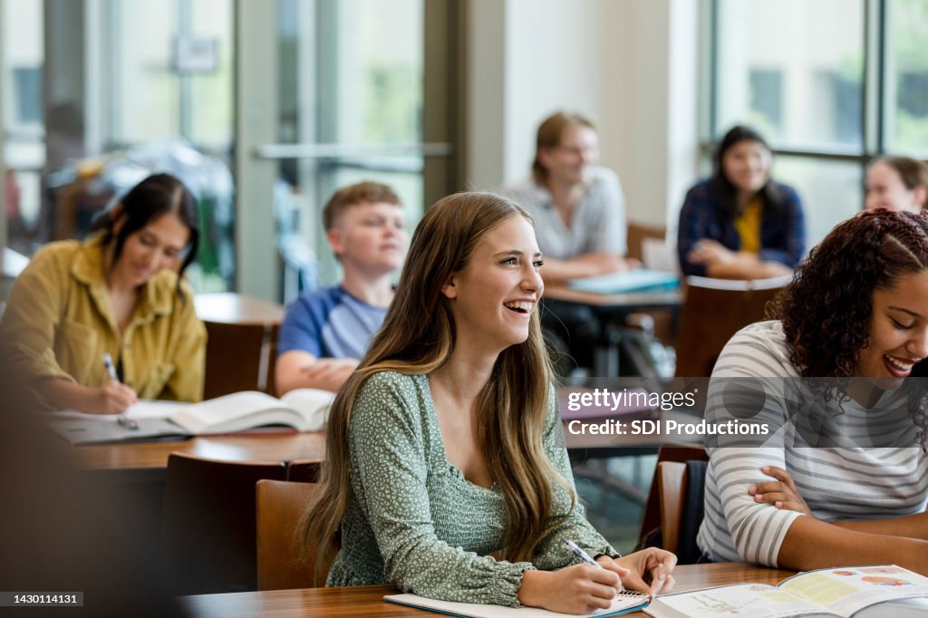 College students taking notes during class