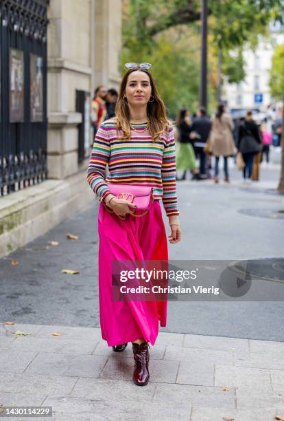 Maria Rosaria Rizzo wears pink skirt, striped jumper, bag, necklace outside Valentino during Paris Fashion Week - Womenswear Spring/Summer 2023 : Day...