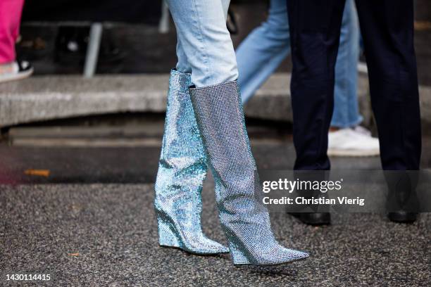 Guest wears glitter blue boots outside Valentino during Paris Fashion Week - Womenswear Spring/Summer 2023 : Day Seven on October 02, 2022 in Paris,...