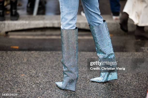 Guest wears glitter blue boots outside Valentino during Paris Fashion Week - Womenswear Spring/Summer 2023 : Day Seven on October 02, 2022 in Paris,...
