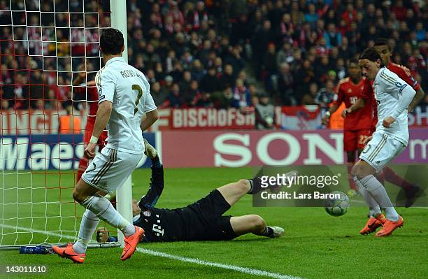 Mesut Oezil of Madrid scores his teams first goal during the UEFA Champoins League Semi Final first leg match between FC Bayern Muenchen and Real...