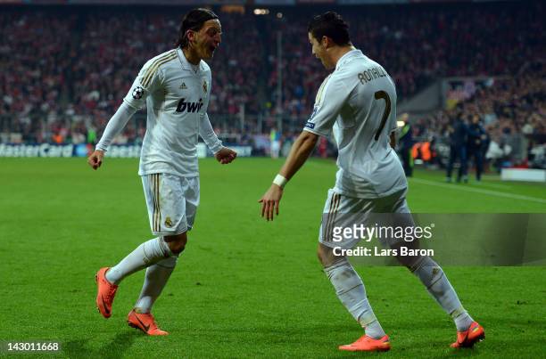 Mesut Oezil of Madrid celebrates with team mate Cristiano Ronaldo after scoring his teams first goal during the UEFA Champoins League Semi Final...